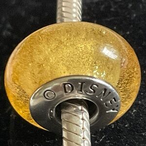 Pandora Disney Belle's Signature Colour Murano Charm glows in dark